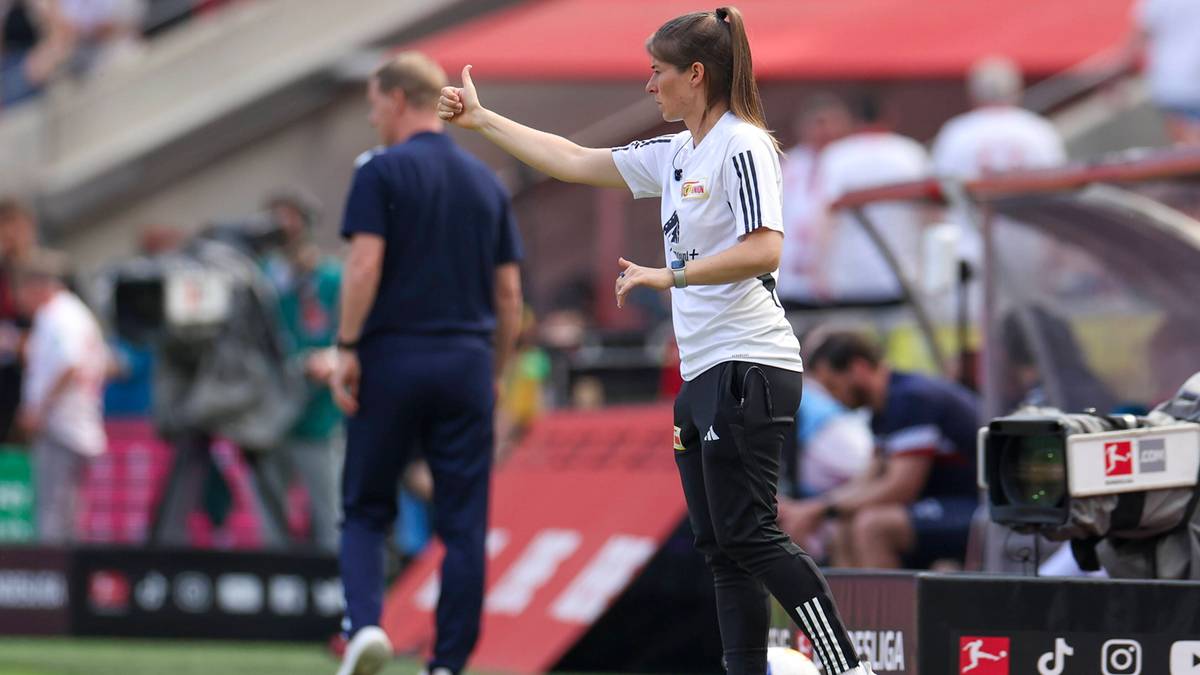 Marie-Louise Eta daje wskaz&oacute;wki na boisku piłkarskim.